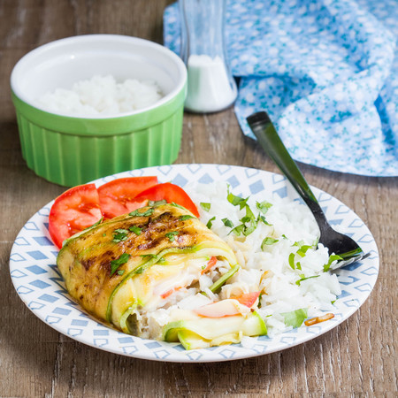 Fish grilled slices of zucchini, with tomatoes and cheese, stuffed vegetables, tasty diet food, healthy foodの写真素材