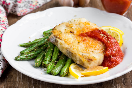 Fried white fish with green beans and tomato sauce, nice homemade meal, healthy diet tasty foodの写真素材