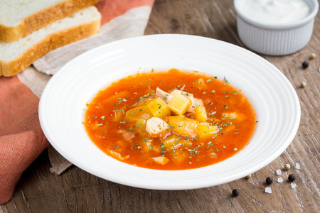 Vegetable soup with tomatoes, paprika, potatoes, chicken and sour cream, delicious first course, Russian cuisine, soup, rustic foodの写真素材