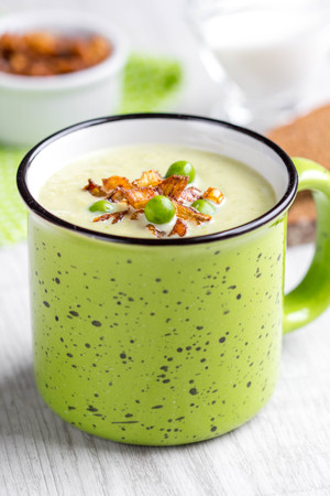 Cream soup of green peas, broccoli, spinach with crispy onion fries in Ñupの写真素材