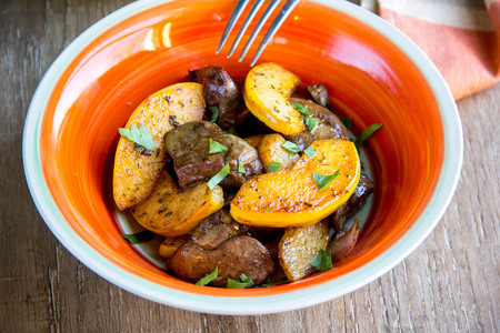 Meat, chicken liver with quince, apples, spices, delicious homemade autumn dishの写真素材