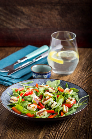 Salad with grilled cheese, spinach, tomatoes, pepper, paprika, delicious lunch diet dishの写真素材