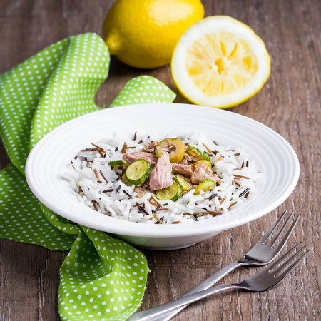 Mix of wild and white rice with canned tuna, zucchini, green olives and lemon, fresh, delicious diet dish, healthy foodの写真素材