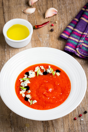 Tomato cream soup, nice presentation with blue cheese and green onions, fresh bright dish, tasty healthy foodの写真素材
