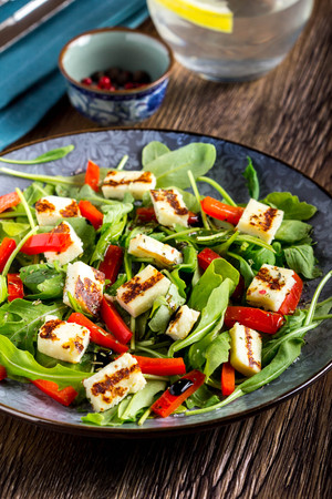Salad with grilled cheese, spinach, tomatoes, pepper, paprika, delicious lunch diet dishの写真素材