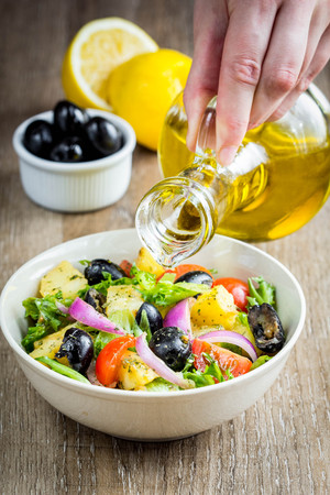 Potato salad with olives, tomatoes, lettuce, red onion, Italian dish, delicious foodの写真素材