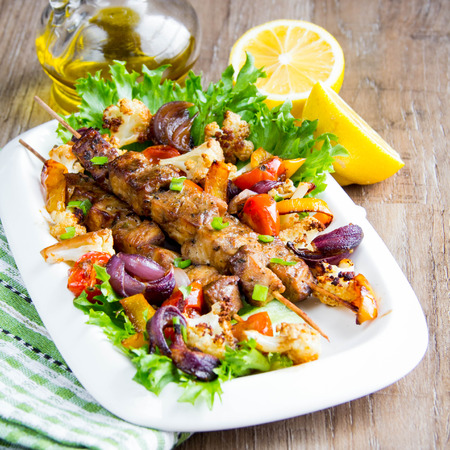 Meat kebabs on skewers with roasted vegetables, grilled fish, spring, summer picnic, tasty foodの写真素材