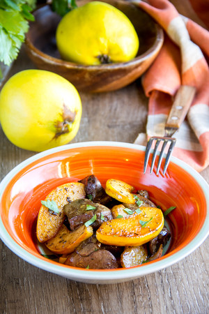 Meat, chicken liver with quince, apples, spices, delicious homemade autumn dishの写真素材