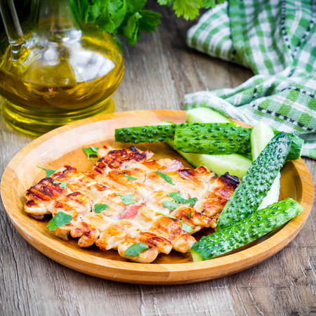 Grilled chicken fillet with bacon, golden brown, delicious dish for picnicの写真素材