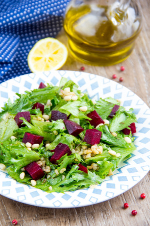 Fresh salad with beets, lettuce, pine nuts, bulgur, vegetarian summer dishの写真素材
