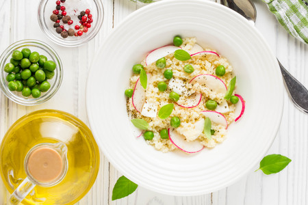Salad with couscous, green peas, mozzarella and radish, summer healthy dishの写真素材
