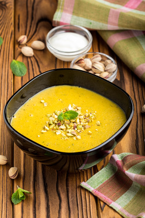 Vegetable cream lentil soup, pumpkin, pistachio and mint, tasty dishの写真素材