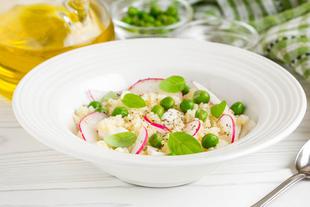 Salad with couscous, green peas, mozzarella and radish, summer healthy dishの写真素材