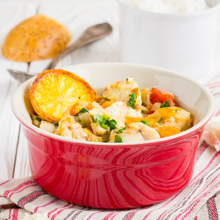 Fish stew with vegetables and rice, delicious healthy dinner, lemon, spices, breadの写真素材