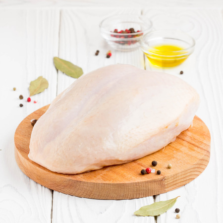 Raw chicken breast with skin, preparation for cooking, baking, spices, olive oilの写真素材