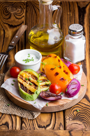 Grilled vegetables with sauce, zucchini, bell peppers, red onions, tomatoes, summer picnicの写真素材