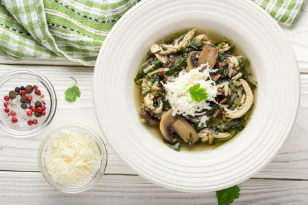 Healthy soup with spinach, chicken, rice, mushrooms and feta cheese, delicious lunch, diet foodの写真素材