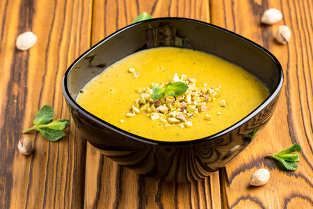 Vegetable cream lentil soup, pumpkin, pistachio and mint, tasty dishの写真素材