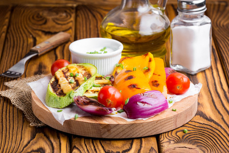 Grilled vegetables with sauce, zucchini, bell peppers, red onions, tomatoes, summer picnicの写真素材