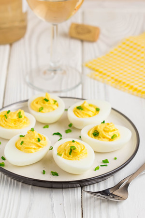 Stuffed eggs, yellow mousse, wine snack, holiday partyの写真素材