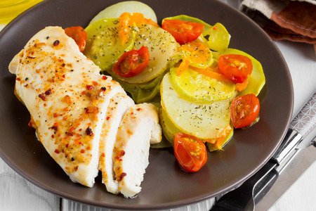 Baked chicken fillet with vegetables, delicious dinnerの写真素材