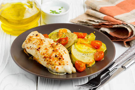 Baked chicken fillet with vegetables, delicious dinnerの写真素材