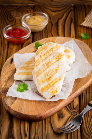 Grilled chicken fillet, mustard and ketchup, tastyの写真素材