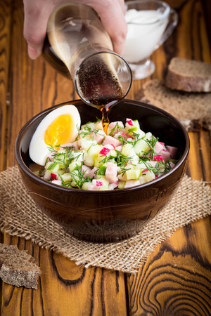 Traditional summer Russian cold soup with kvass, okroshka with ham and vegetables, foodの写真素材