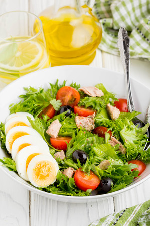 Salad with tuna, egg, cherry tomatoes, olives, oilの写真素材
