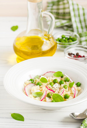 Salad with couscous, green peas, mozzarella and radish, summer healthy dishの写真素材