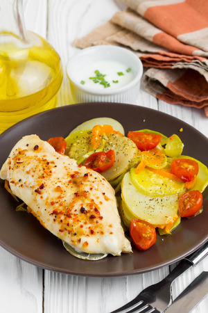 Baked chicken fillet with vegetables, delicious dinnerの写真素材