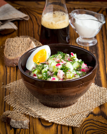 Traditional summer Russian cold soup with kvass, okroshka with ham and vegetables, foodの写真素材