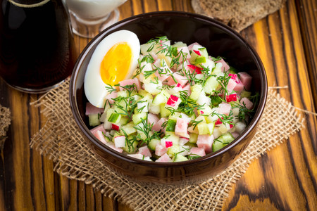 Traditional summer Russian cold soup with kvass, okroshka with ham and vegetables, foodの写真素材