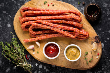 Long smoked sausages with ketchup and mustard, tasty snackの写真素材