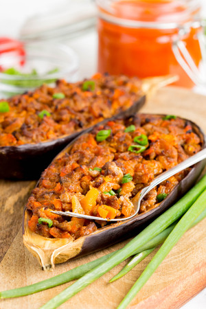 Stuffed eggplant, aubergine, ground beef, pork, vegetables, tomato sauce, rustic styleの写真素材