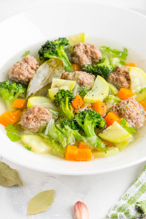 Vegetable soup with beef meatballs, carrots, cabbage, zucchini, broccoli, tatsy healthy homemade lunchの写真素材