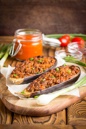 Stuffed eggplant, aubergine, ground beef, pork, vegetables, tomato sauce, rustic styleの写真素材