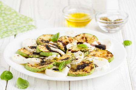 Salad slices of fried zucchini with mozzarella, light summer snackの写真素材