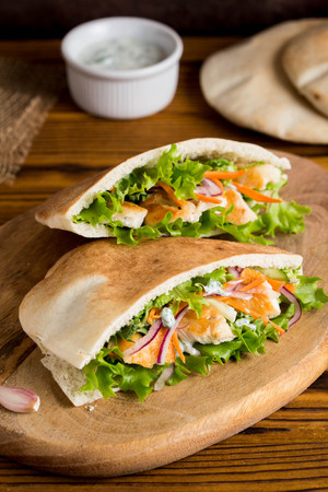 Pita with chicken, vegetables and sauce, delicious lunch, fast food, stuffed rollの写真素材