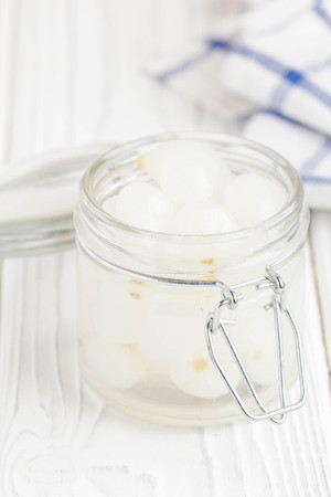 Marinated pearl onion in glass jar, pickled snackの写真素材