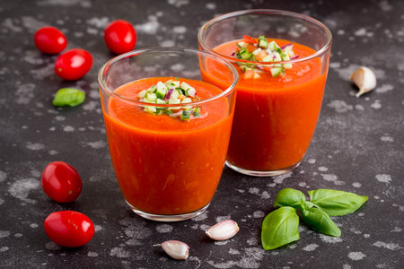 Italian red tomato cold gazpacho soup in glass, with cucumber, onion, Basilの写真素材