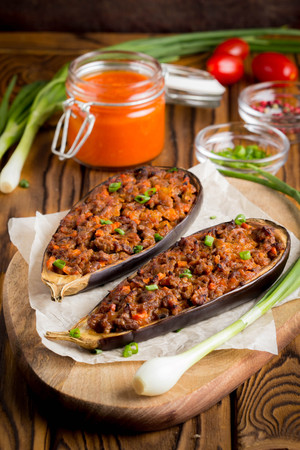 Stuffed eggplant, aubergine, ground beef, pork, vegetables, tomato sauce, rustic styleの写真素材