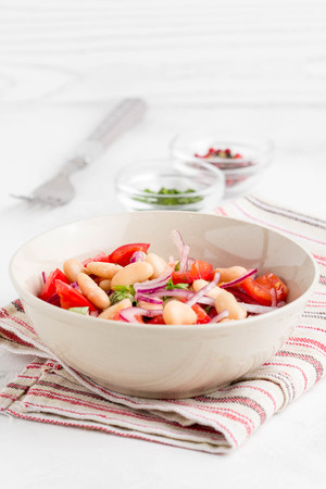 Salad with white beans, tomatoes, red onions, green coriander, parsley, delicious diet lunchの写真素材