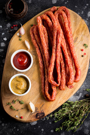 Long smoked sausages with ketchup and mustard, tasty snackの写真素材