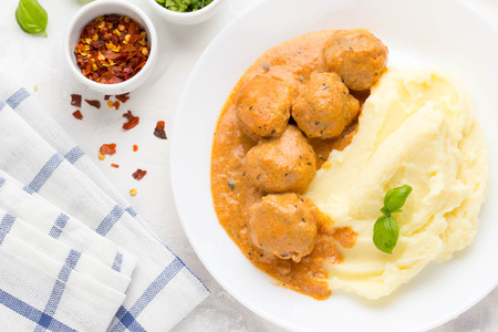 Meatballs with mashed potatoes, creamy tomato sauce, classic delicious foodの写真素材