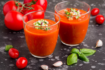Italian red tomato cold gazpacho soup in glass, with cucumber, onion, Basilの写真素材