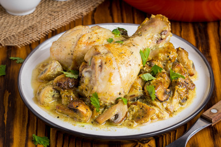 Chicken legs in creamy mushroom sauce, delicious dinnerの写真素材