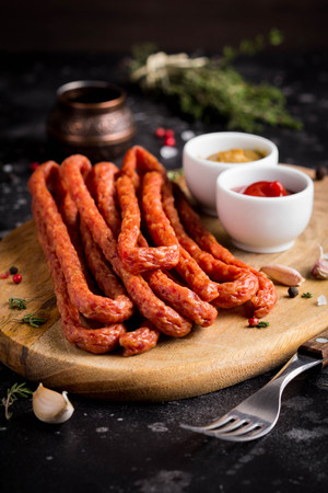 Long smoked sausages with ketchup and mustard, tasty snackの写真素材