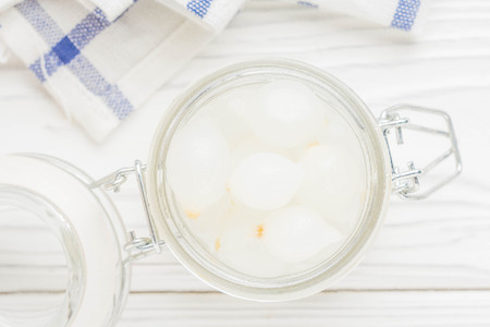 Marinated pearl onion in glass jar, pickled snackの写真素材
