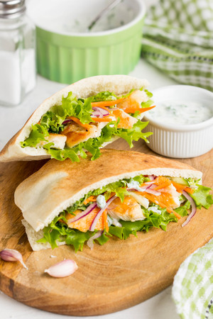 Pita with chicken, vegetables and sauce, delicious lunch, fast food, stuffed rollの写真素材